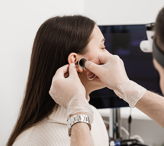 woman receiving otoscopy. Otolaryngology Singapore