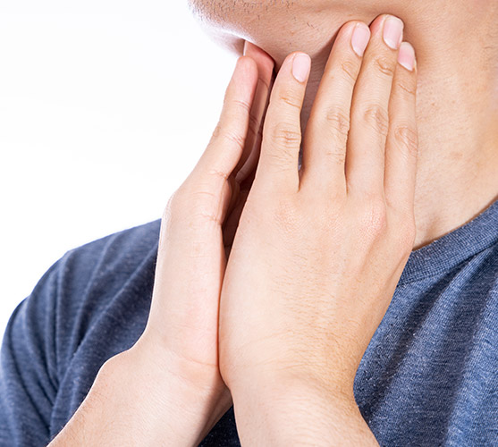 man checking for swelling in his neck